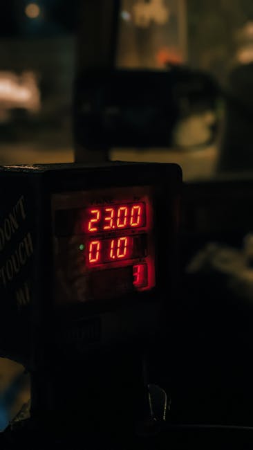 pexels-photo-29114633-29114633 Close-up of an illuminated taxi meter showing fares and distance in Mumbai, India. Captured at night.